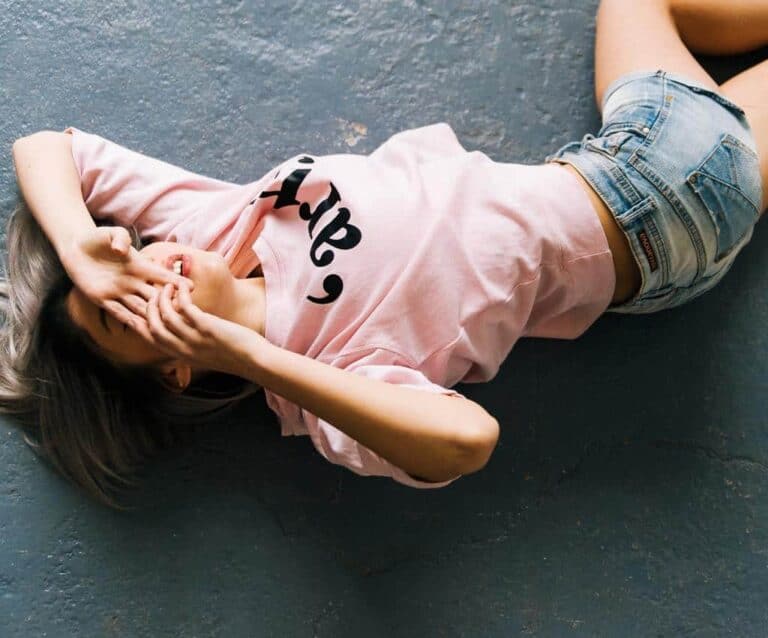 A person lying in the legs of a person