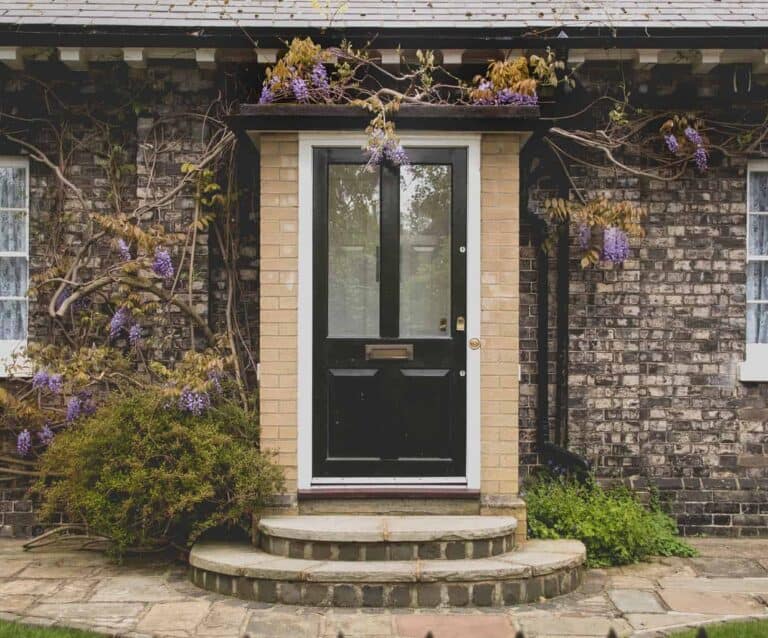 A bench in front of a brick building