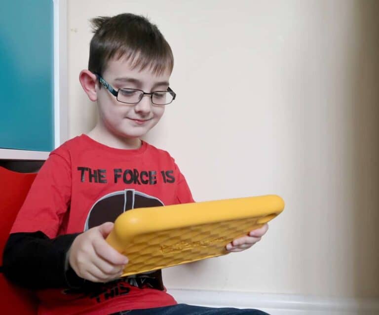 A young boy holding a banana