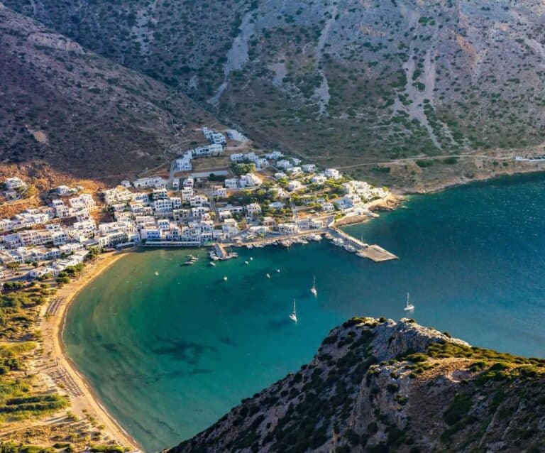 A body of water with a mountain in the background