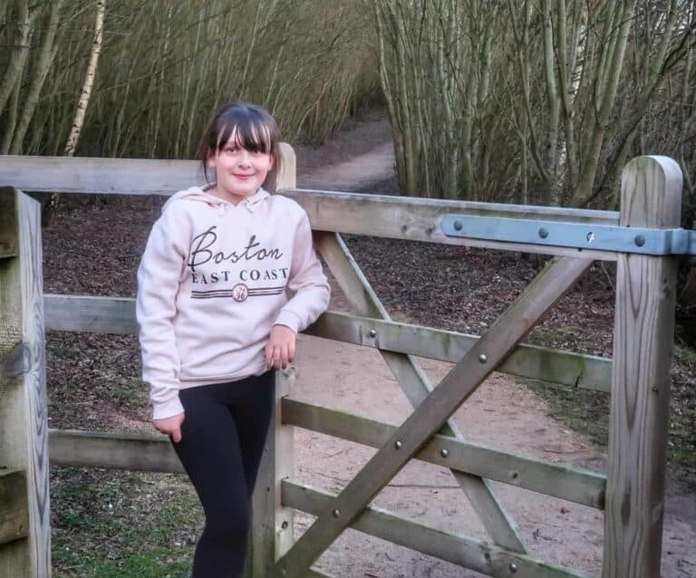 A person sitting on a bench posing for the camera