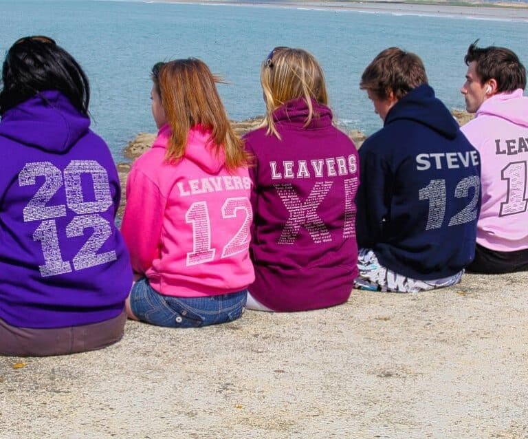 A group of people standing next to a body of water