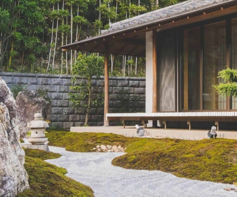 A large stone statue in front of a house