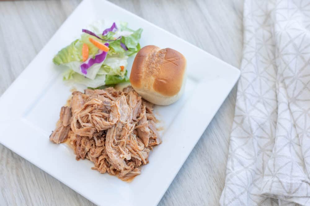 A plate of food on a table, with Pork and Pulled pork