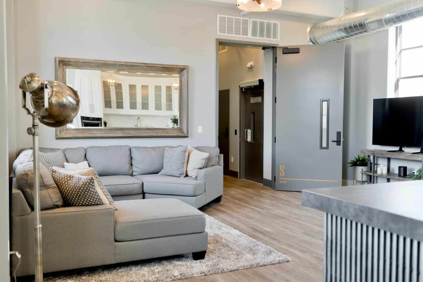 A living room with a sink and a window