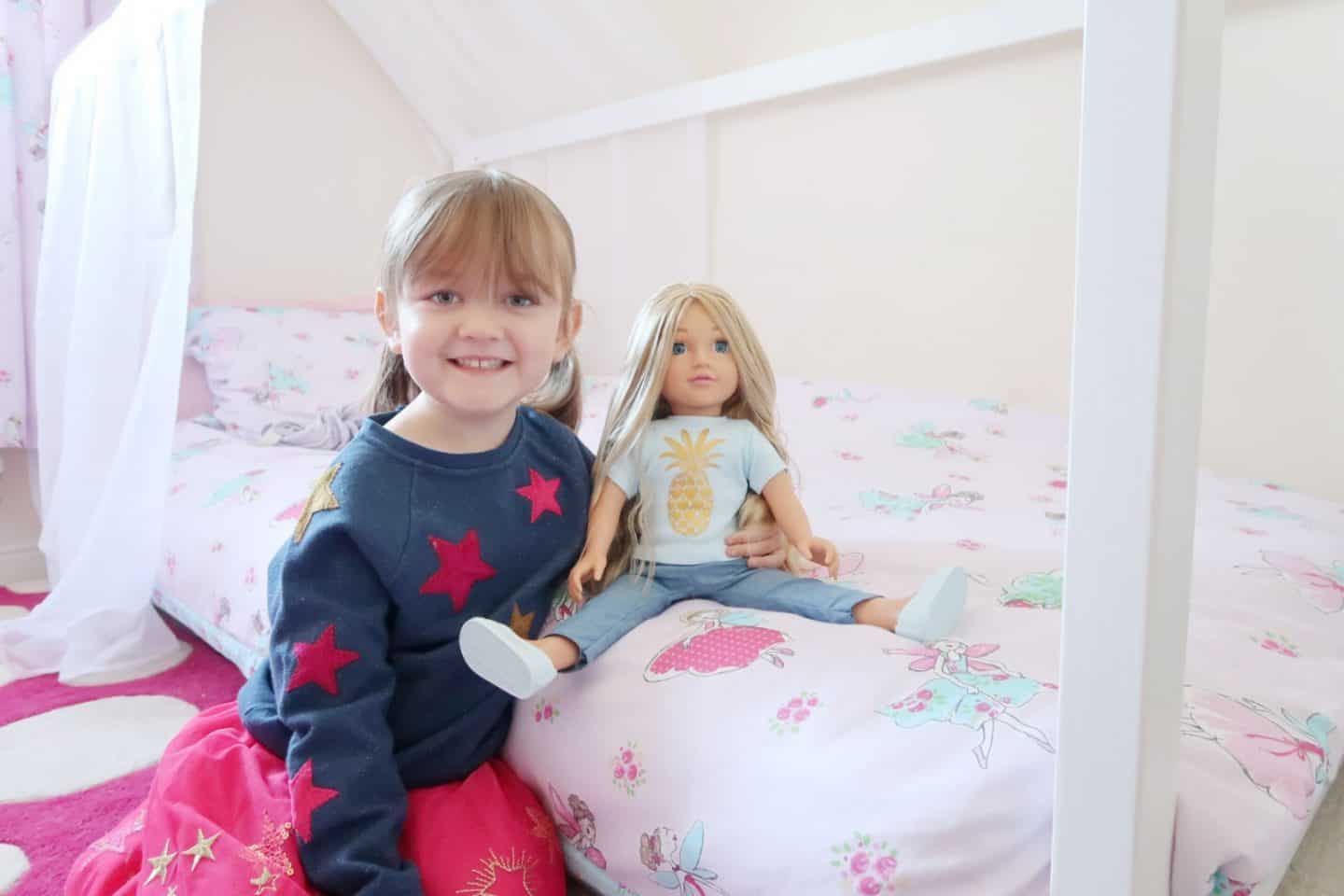 A little girl sitting on a bed