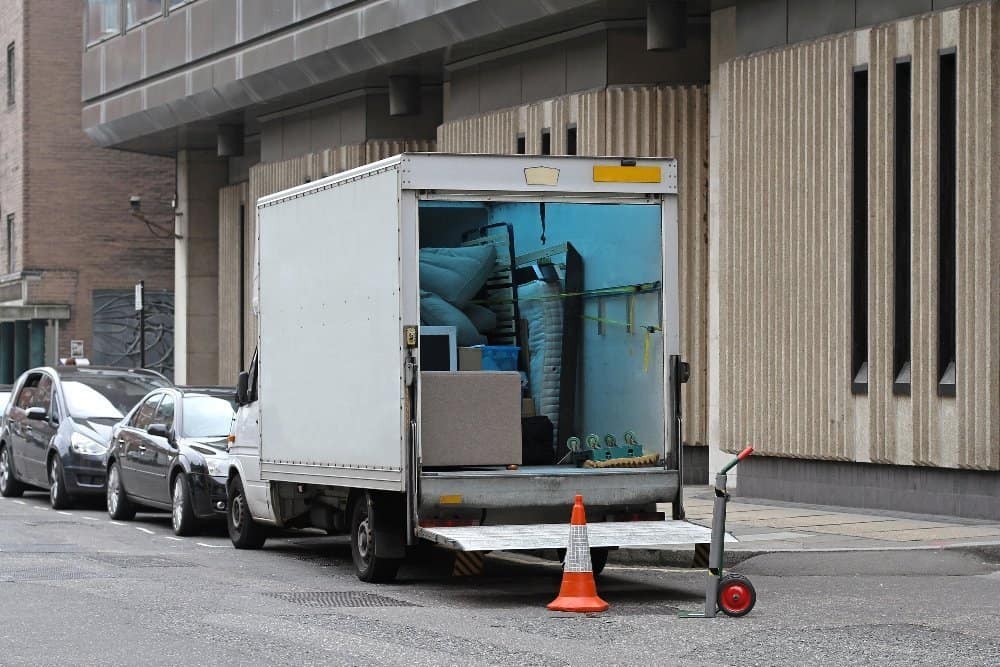 A truck that is sitting on the side of a building