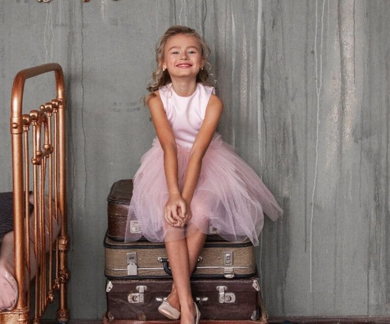 A person sitting on a suitcase