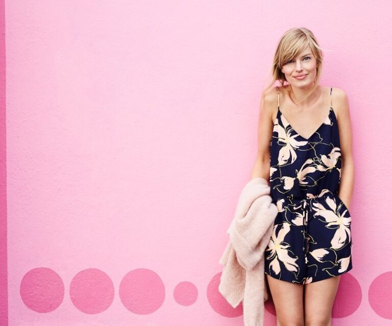 A woman standing in front of a wedding dress