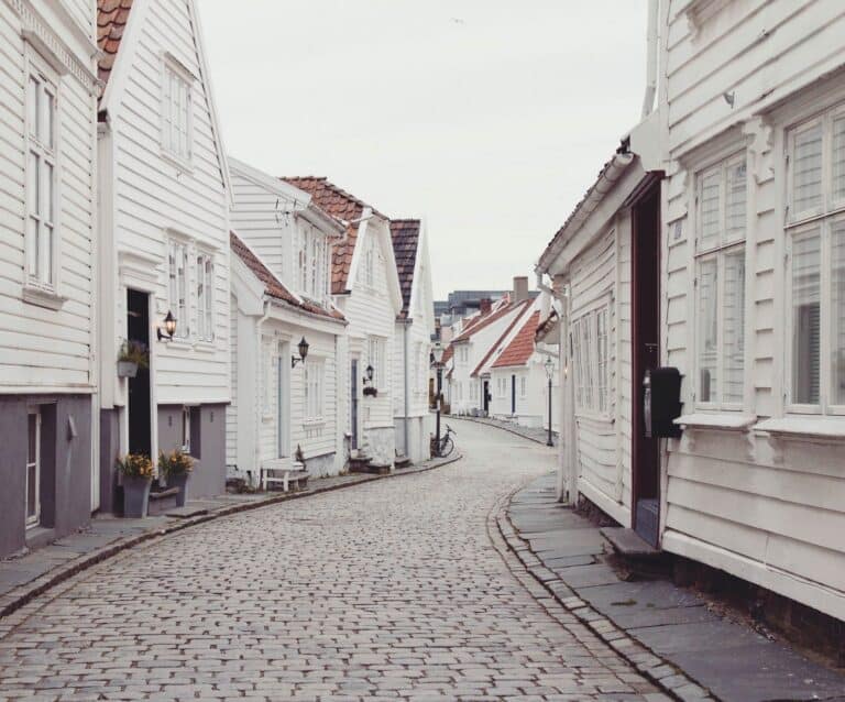 empty roadway between white houses