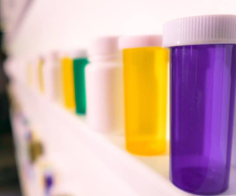 shelves of pill bottles with thousands of pills on the floor