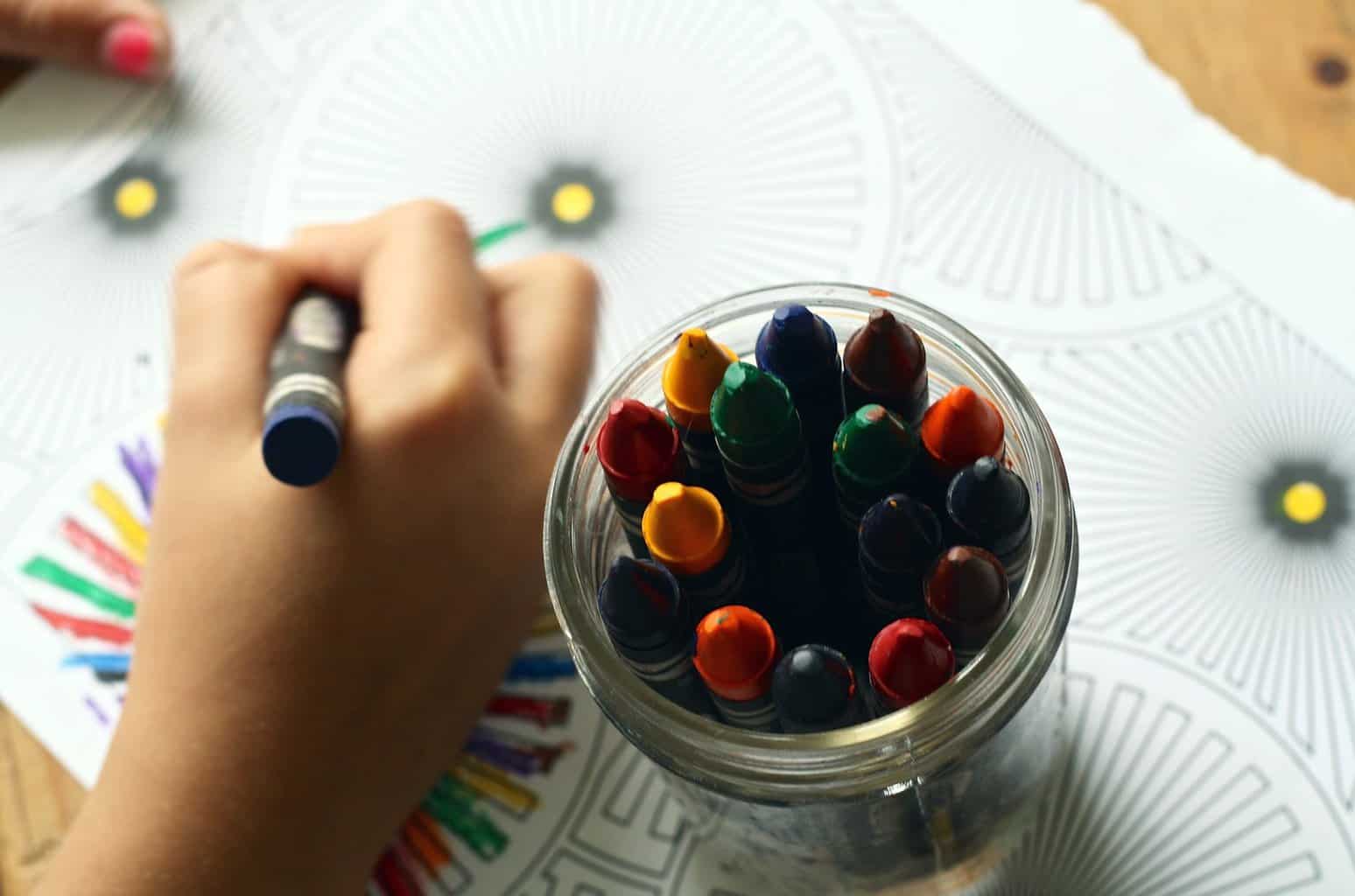 Ways can you prevent the summer slump - person coloring art with crayons