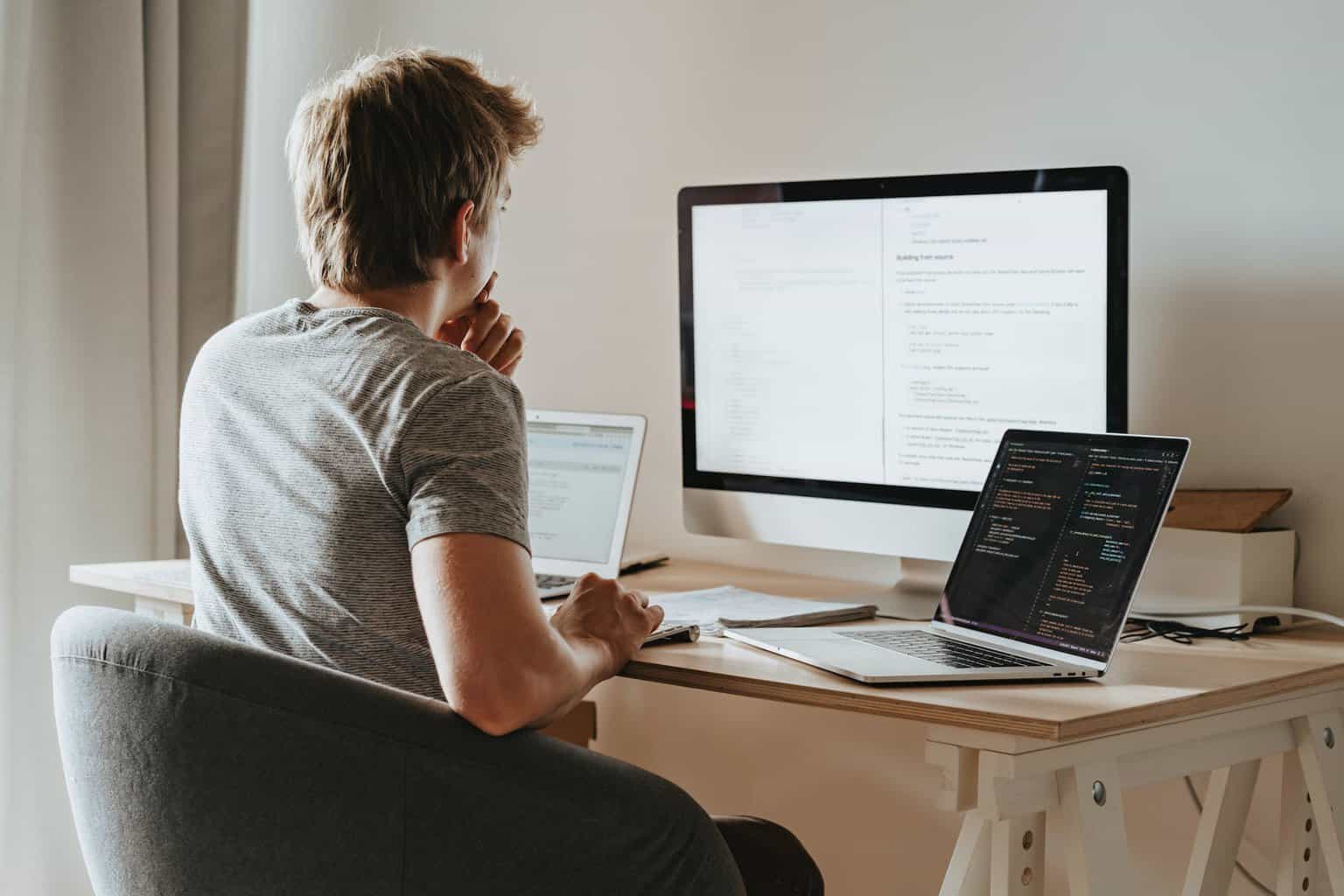 To Grow Your Business Using Technology
 - man sitting in front of three computers