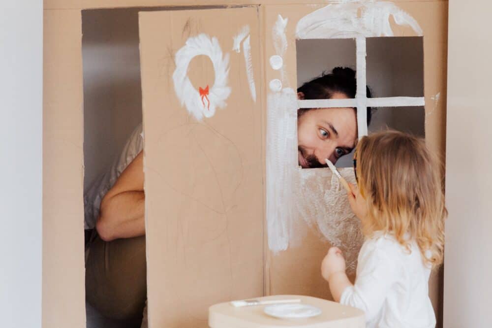 Indoor winter activities for the family - girl in white long sleeve shirt sitting on bed