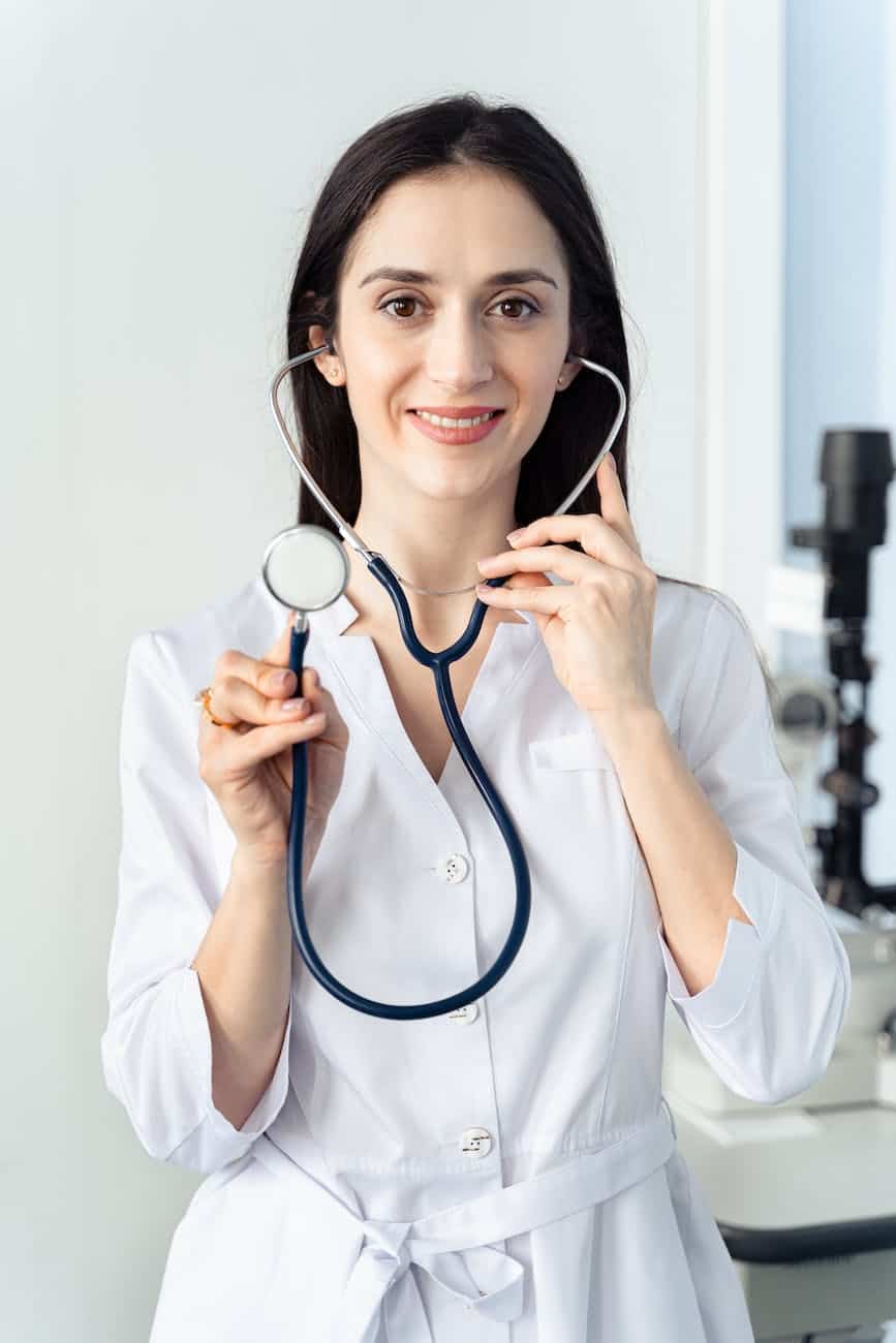 woman smiling while holding a stethoscope - 5 Things to Consider Before Finding Your Next Physician Job