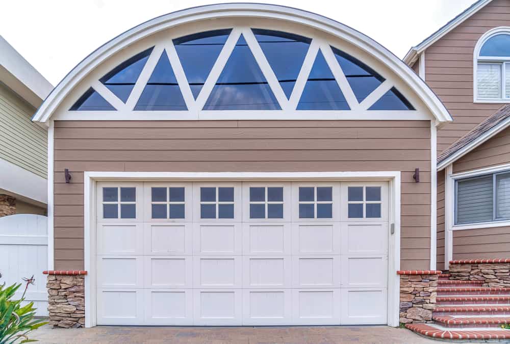 Garage of home in San Diego California with arched roof and glass paned door