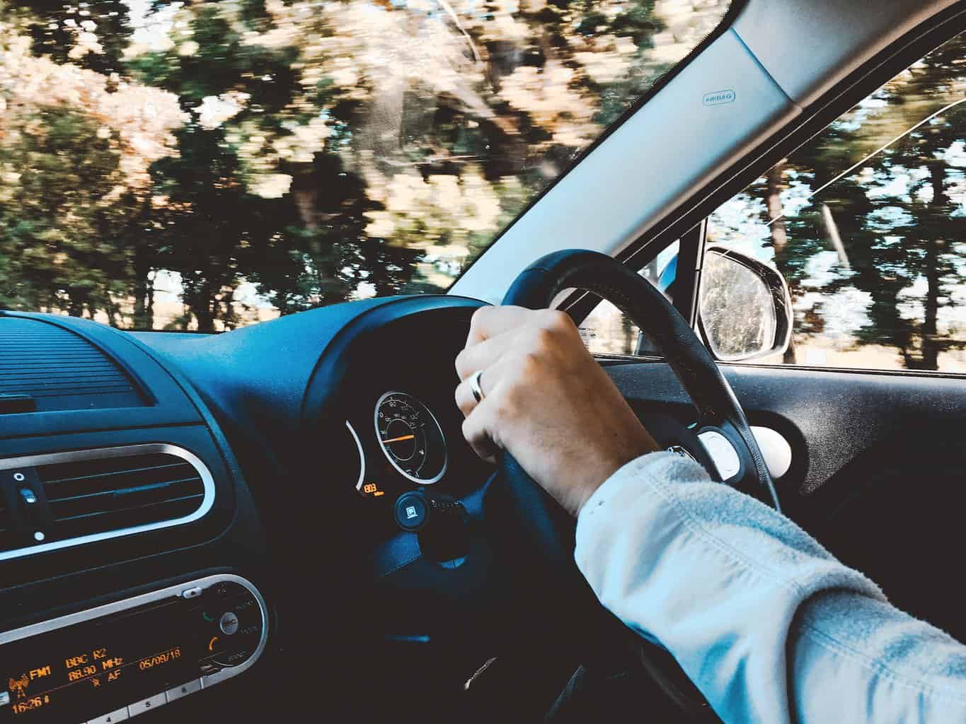 person holding black vehicle steering wheel - Top 5 Tips For Becoming a Good Driver